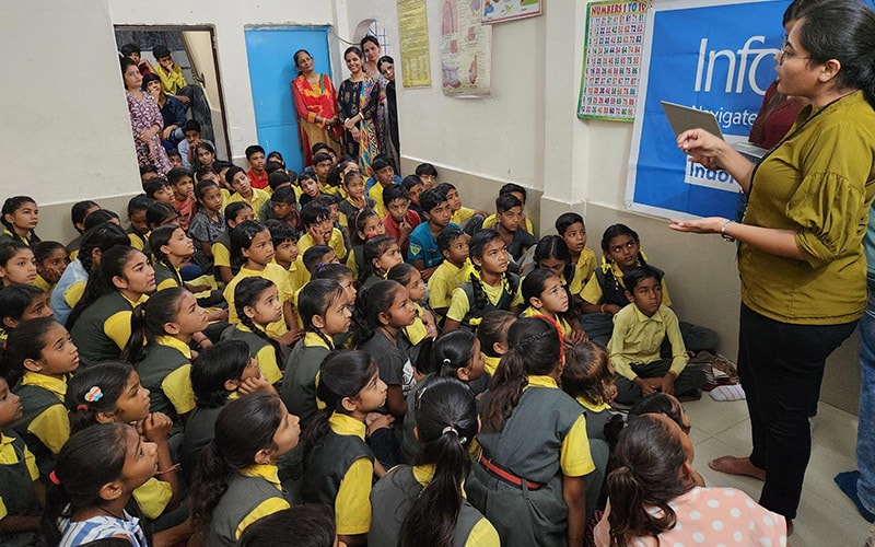 Infosys volunteers having an interaction with children about their aspirations and sharing stories of their own career journeys.